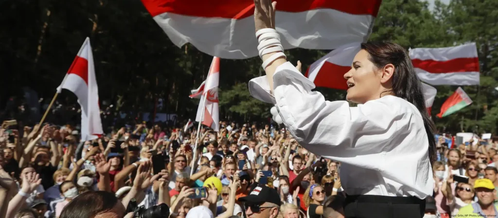 Sviatlana Tsikhanouskaya addressing a crowd during a pro-democracy rally in 2025, symbolizing the strength of the Belarusian opposition in exile and ongoing resistance against Lukashenko’s regime.