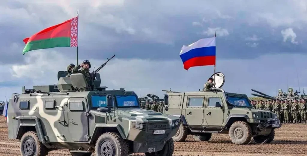"Military vehicles with Belarus and Russia flags during joint drills, illustrating the geopolitical tension in the Belarus vs Ukraine conflict."