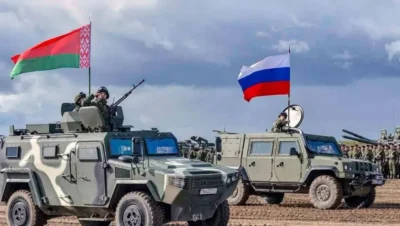 "Military vehicles with Belarus and Russia flags during joint drills, illustrating the geopolitical tension in the Belarus vs Ukraine conflict."