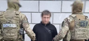 Security officers detain a man during an operation linked to the role of the Belarus KGB in state repression in 2025.