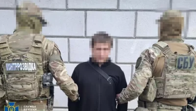 Security officers detain a man during an operation linked to the role of the Belarus KGB in state repression in 2025.