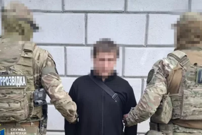 Security officers detain a man during an operation linked to the role of the Belarus KGB in state repression in 2025.